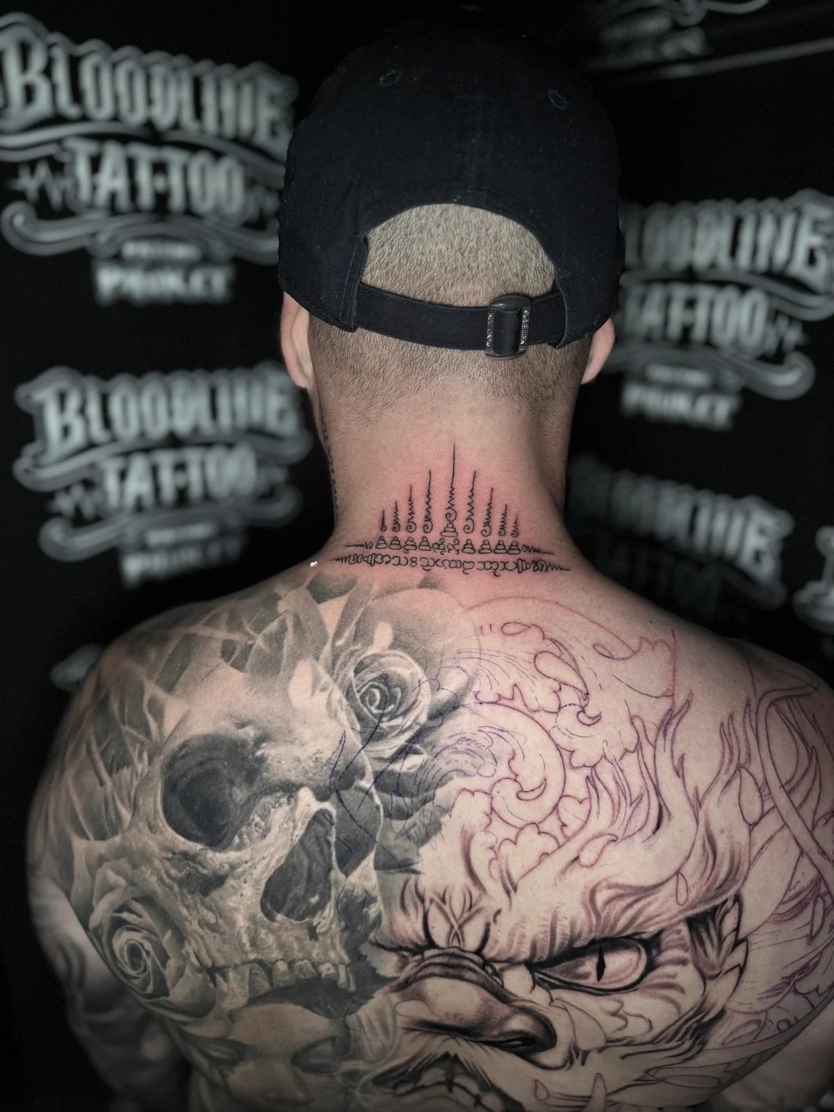 Gao Yord (Nine Spires) Sak Yant with nine peaked unalomes rising from a Khom script base on the back of the neck at Bloodline Tattoo Phuket.