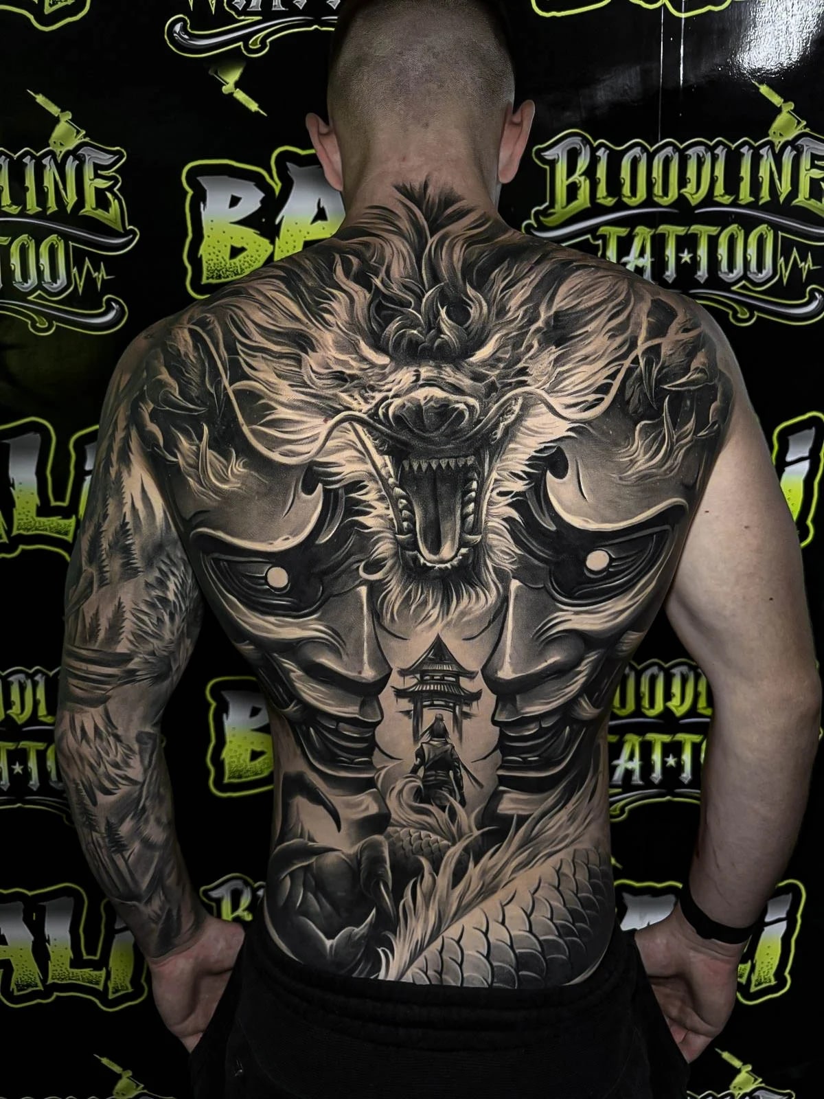 Healed full-back dragon composition with mirrored Hannya masks, pagoda detailing, and soft greywash transitions holding strong line integrity at Bloodline Tattoo Bali.